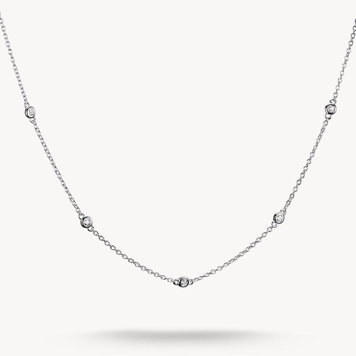 Silver necklace with small diamonds on a white background
