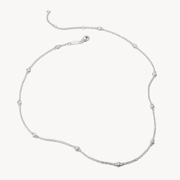 Silver necklace with small beads on a white background