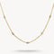 Gold necklace with small diamonds on a light gray background