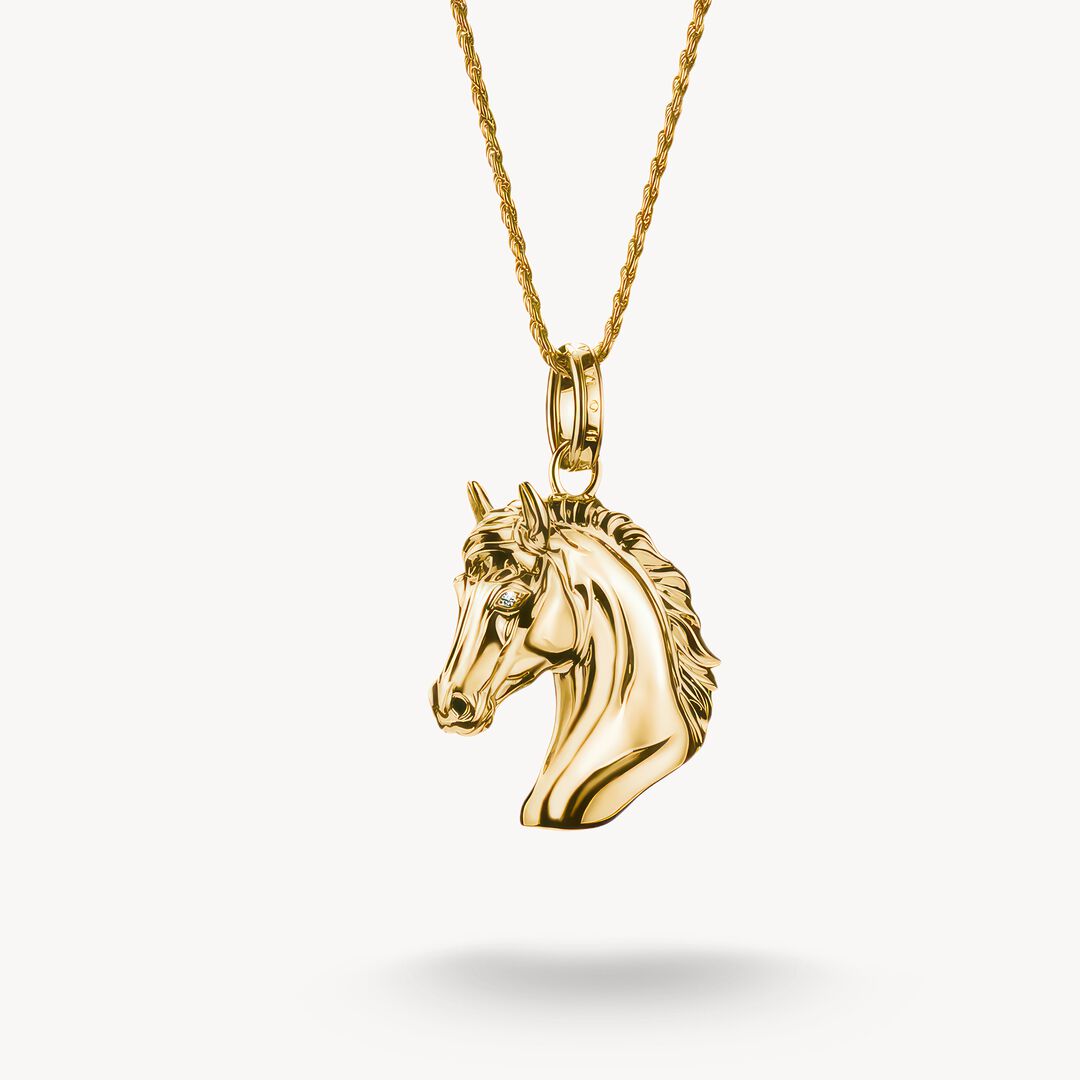 Gold horse head pendant on a gold chain against a white background