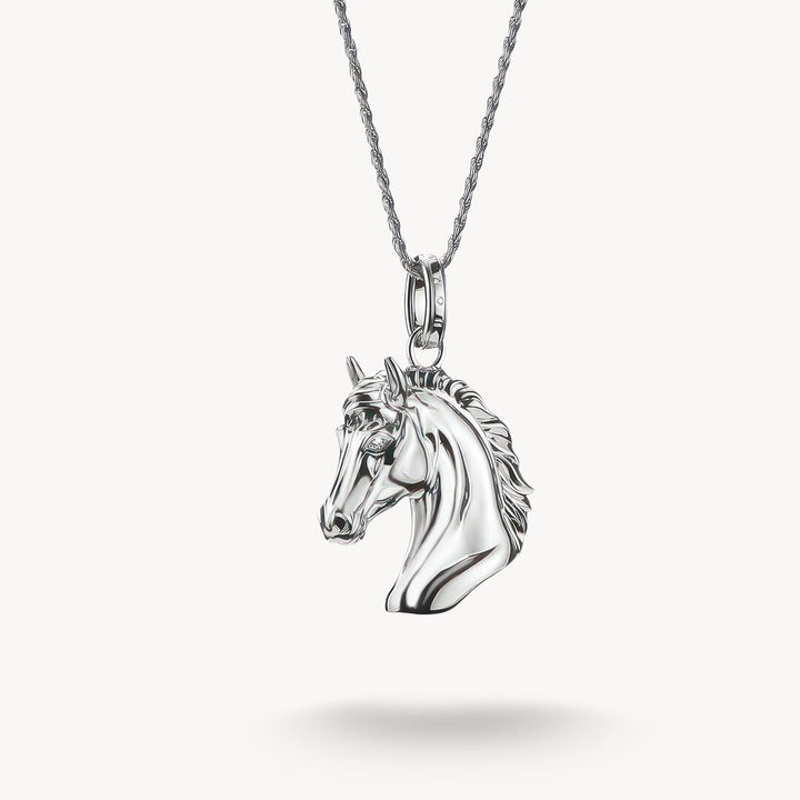 Silver horse head pendant on a chain against a white background