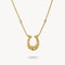 Gold horseshoe necklace with small diamonds on a white background