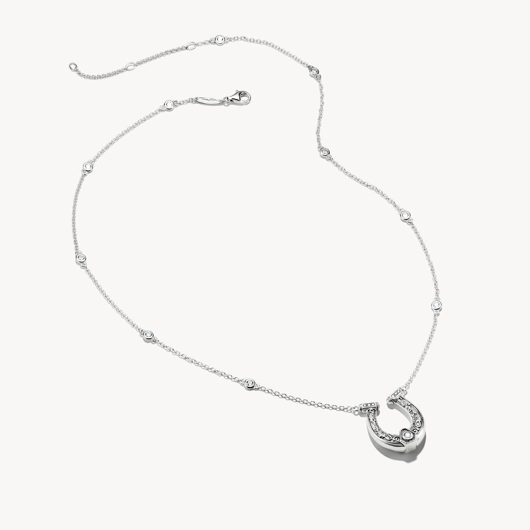 Silver necklace with a heart-shaped pendant on a white background