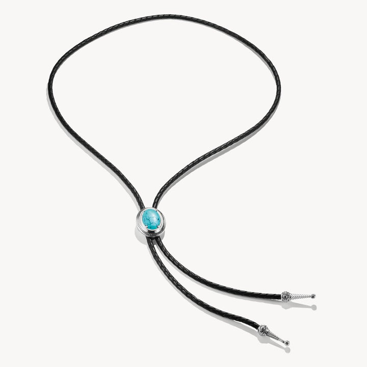 Bolo tie with turquoise stone and black cord on a white background