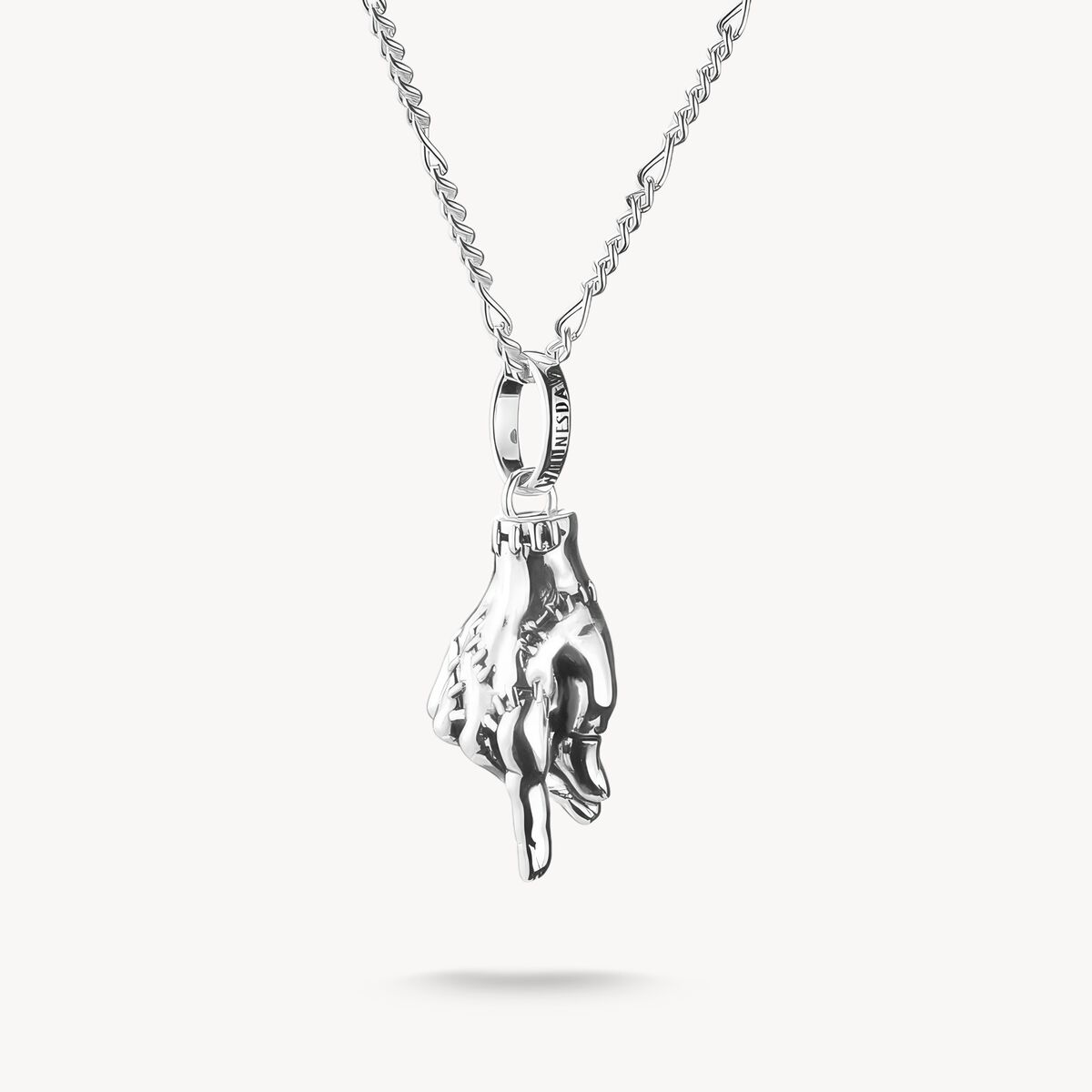 Silver hand-shaped pendant on a chain against a white background