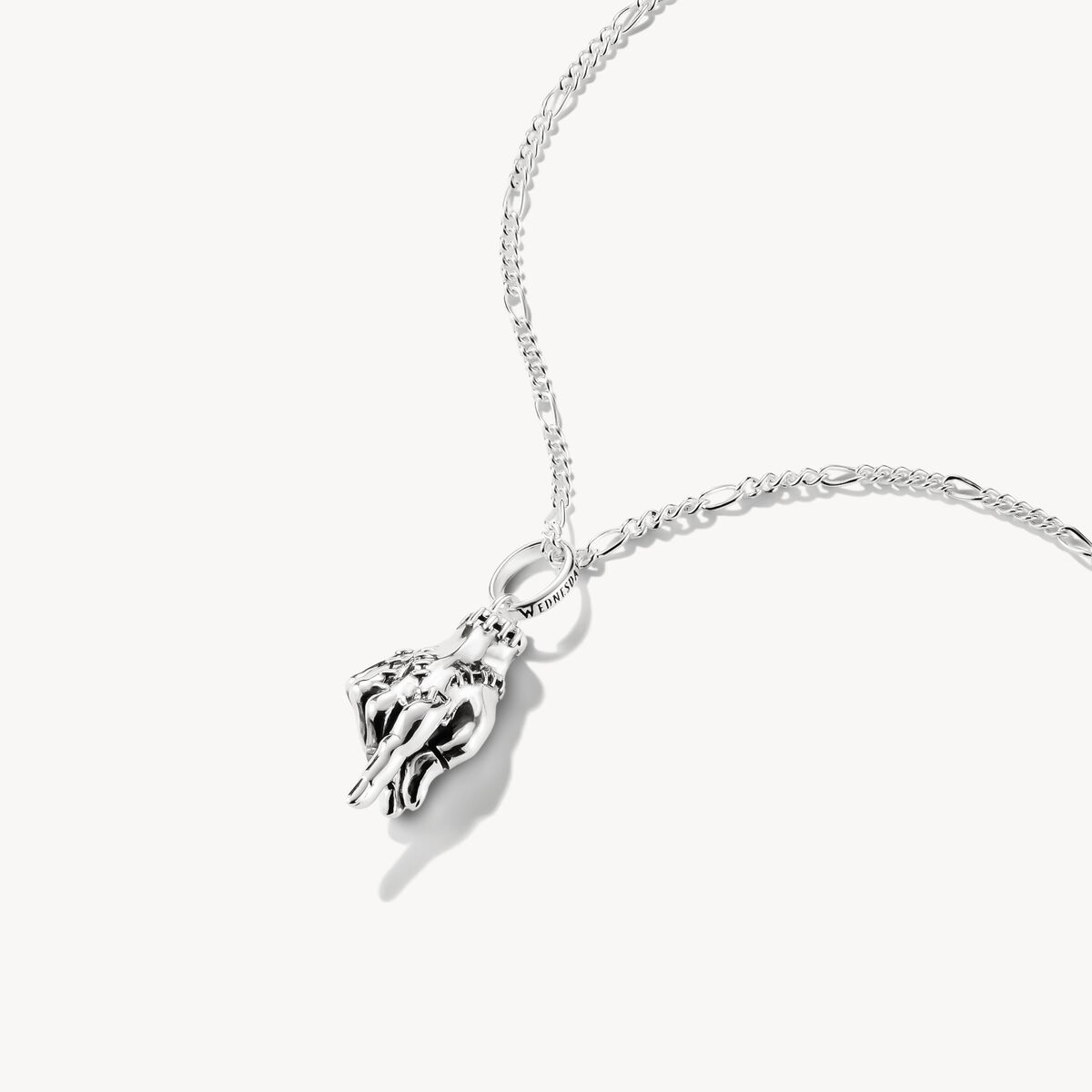 Silver hand-shaped pendant on a chain against a white background