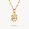 Gold pendant necklace with a central pearl and teardrop-shaped gemstone on a white background