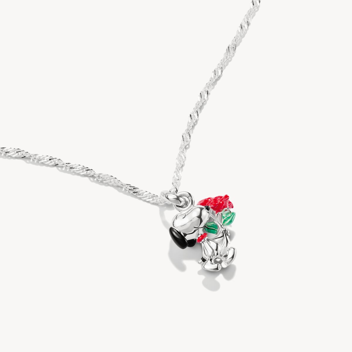 Silver necklace with a rose charm on a white background