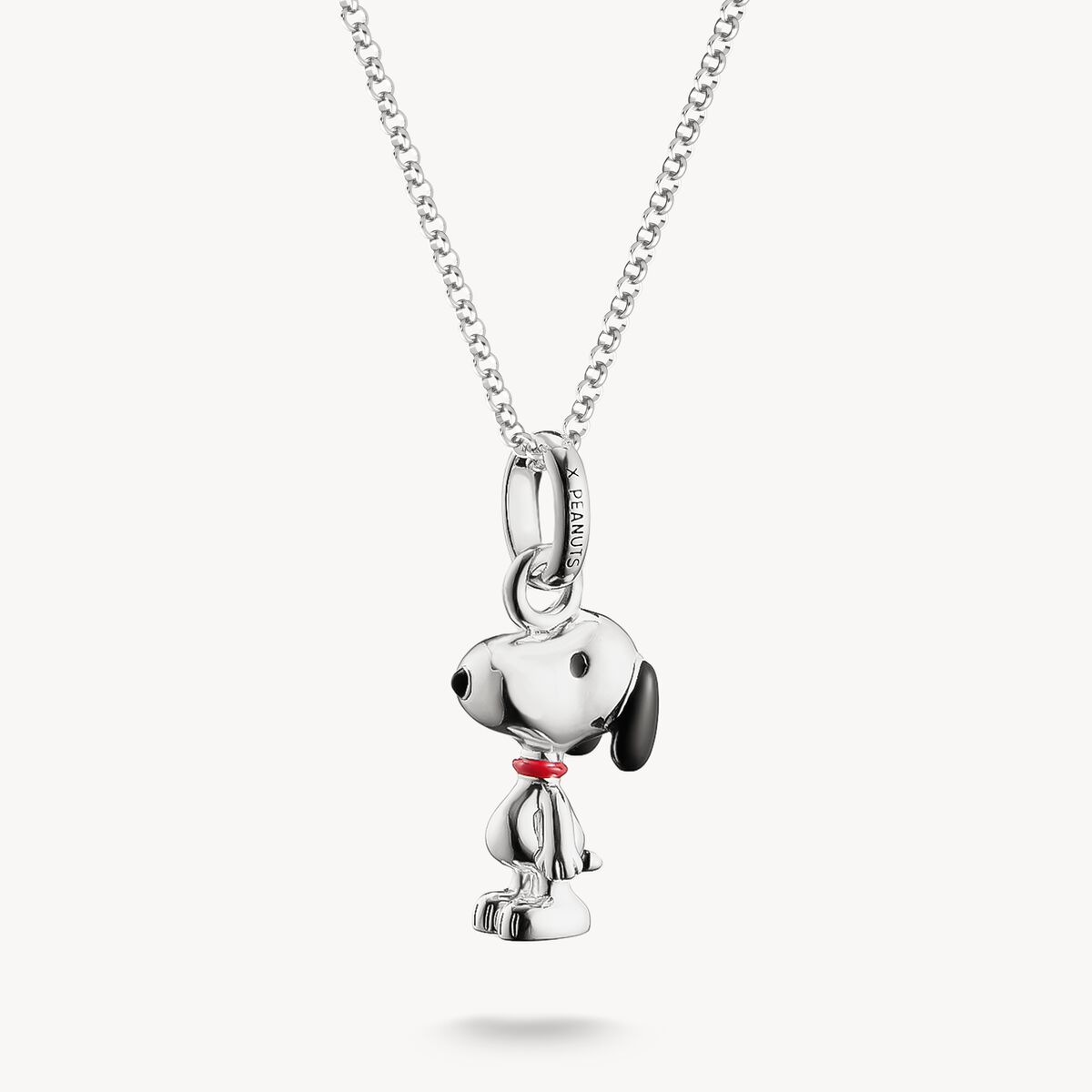 Silver dog-shaped pendant on a chain against a white background