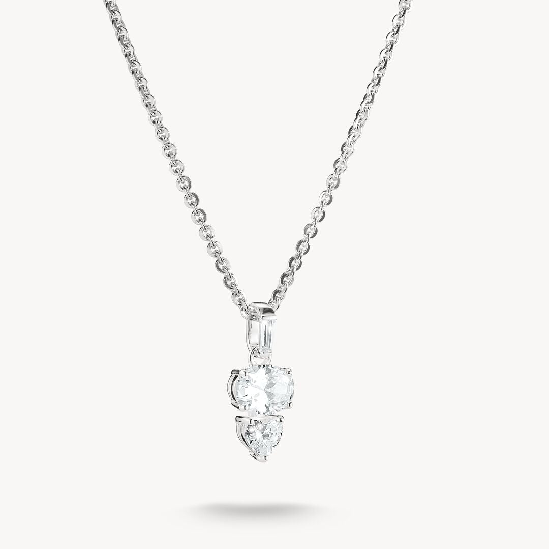 Diamond necklace with two heart-shaped pendants on a white background