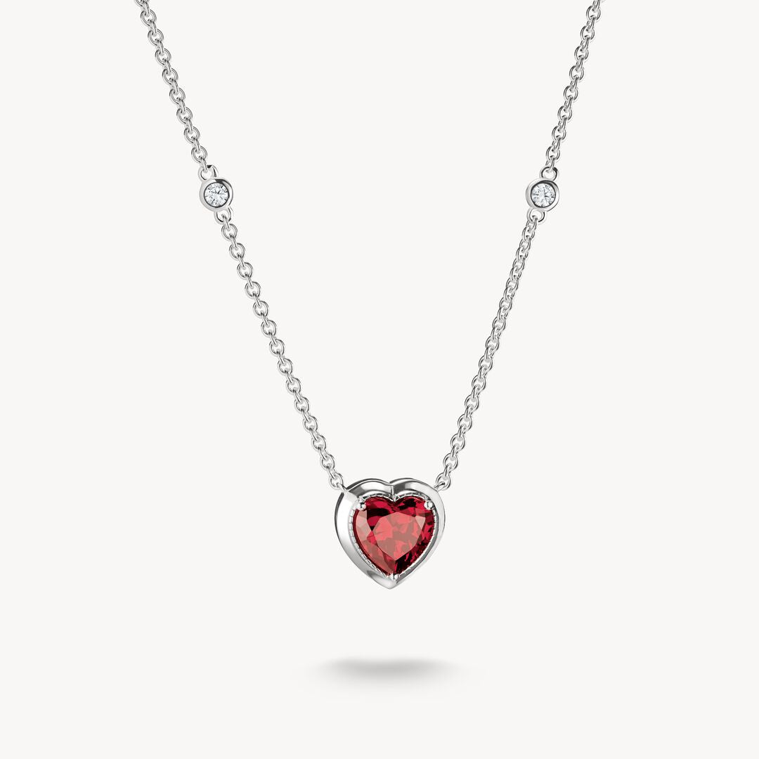 Necklace with a heart-shaped red gemstone pendant on a white background