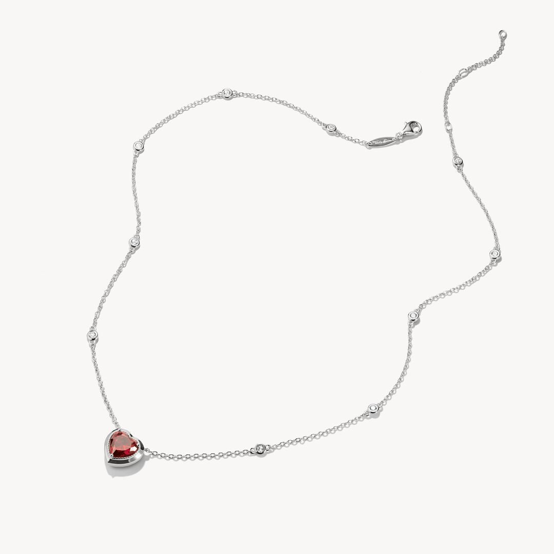 Necklace with a heart-shaped red gemstone pendant on a white background