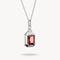 Silver pendant with a red gemstone on a white background