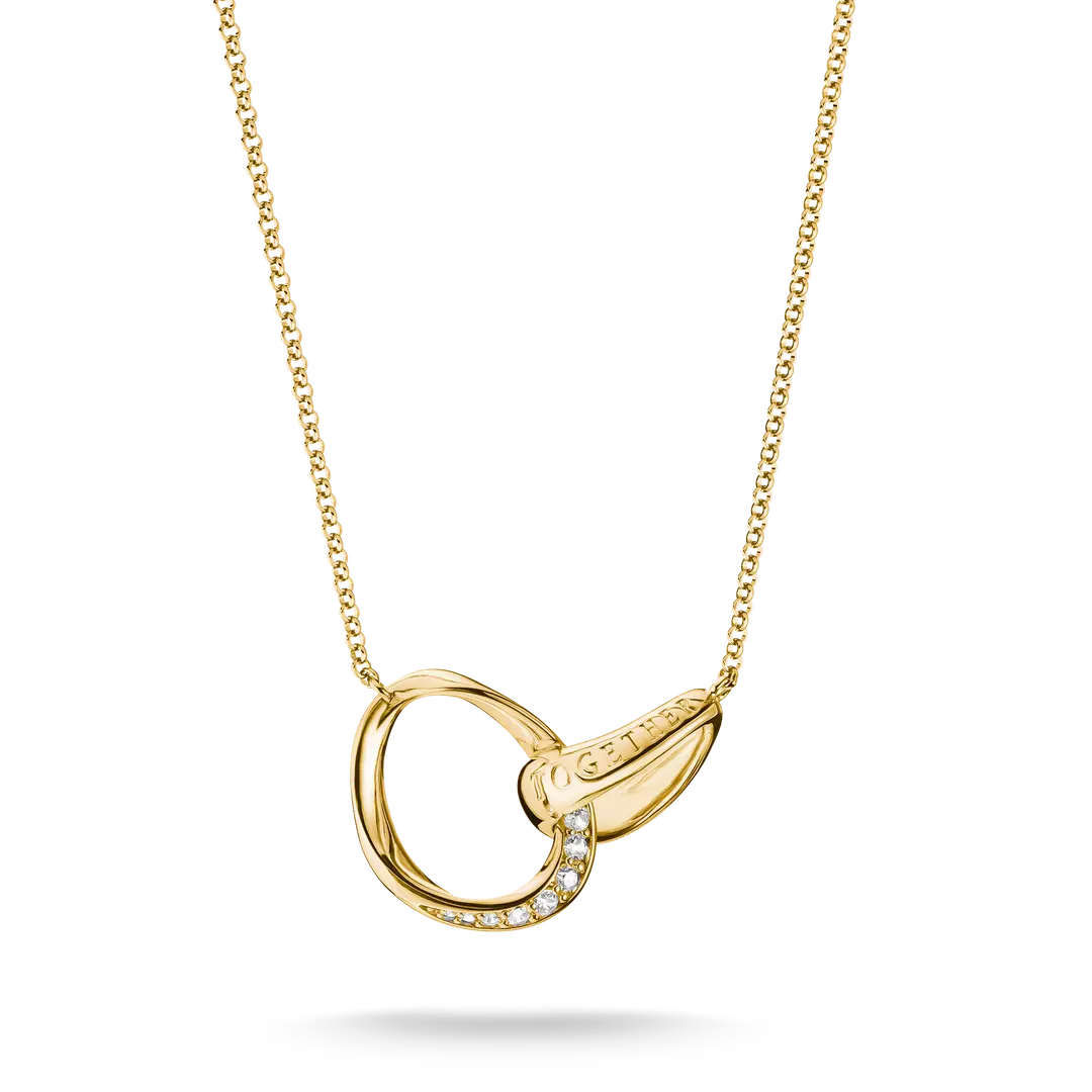 A gold necklace featuring an open interlocking ring pendant with a small row of clear stones on one side and a teardrop-shaped gold element on the other, shown on a white background.