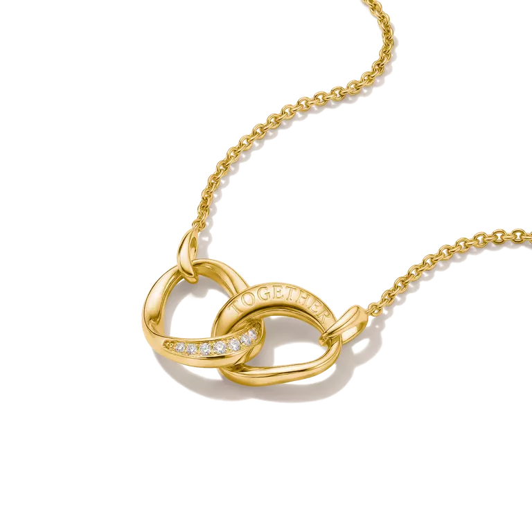 A gold necklace with an interlocking knot pendant, featuring a curved section paved with small clear stones and the word 'LOVE' engraved on the top loop, shown against a plain white background.