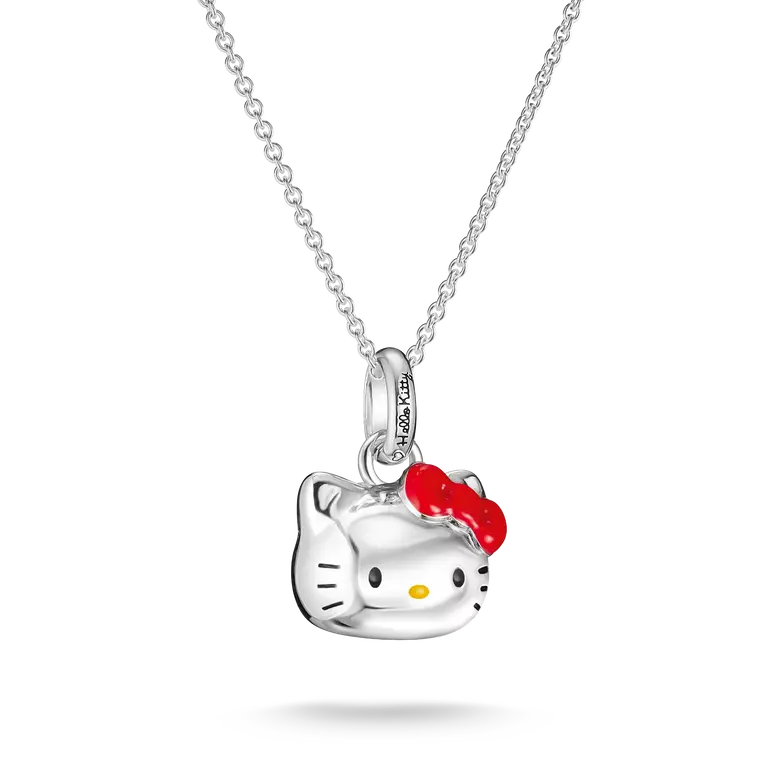 A silver Hello Kitty pendant necklace featuring a polished silver cat head with a bright red bow and small yellow nose, hanging from a delicate silver chain against a white background.