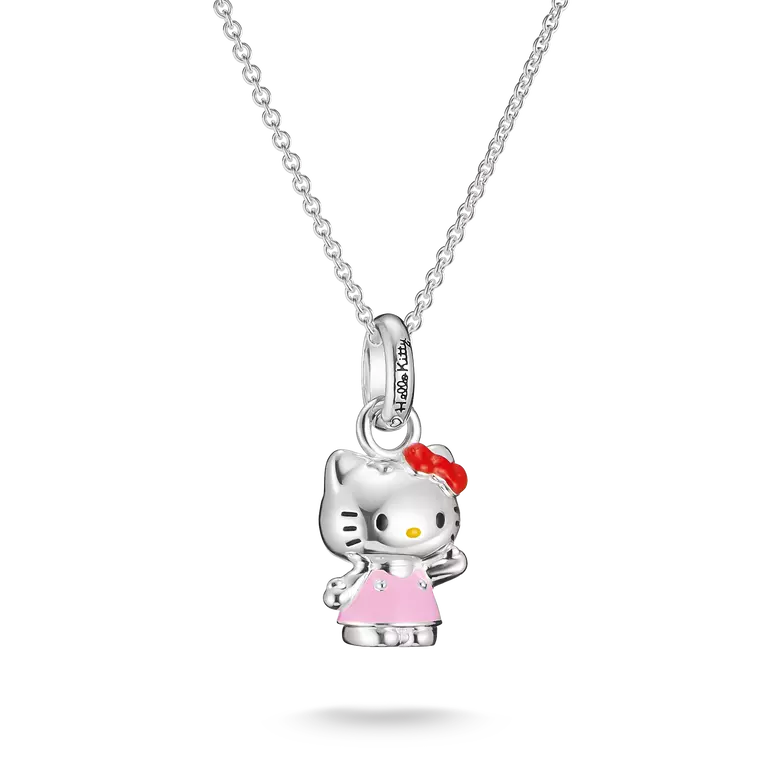 A silver Hello Kitty pendant necklace featuring a silver Hello Kitty figure wearing a pink dress and red bow, suspended from a silver cable chain on a white background.