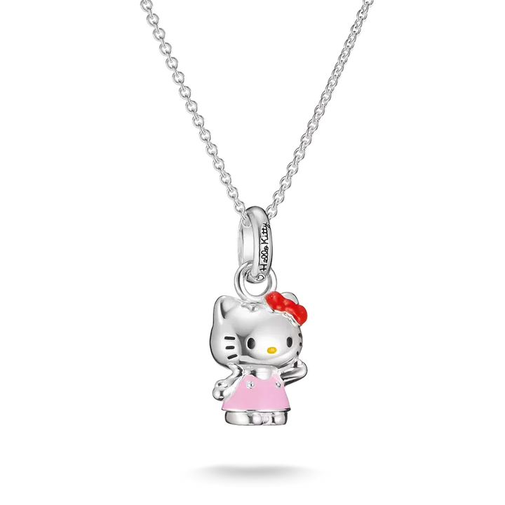 A silver Hello Kitty pendant necklace featuring a silver Hello Kitty figure wearing a pink dress and red bow, suspended from a silver cable chain on a white background.