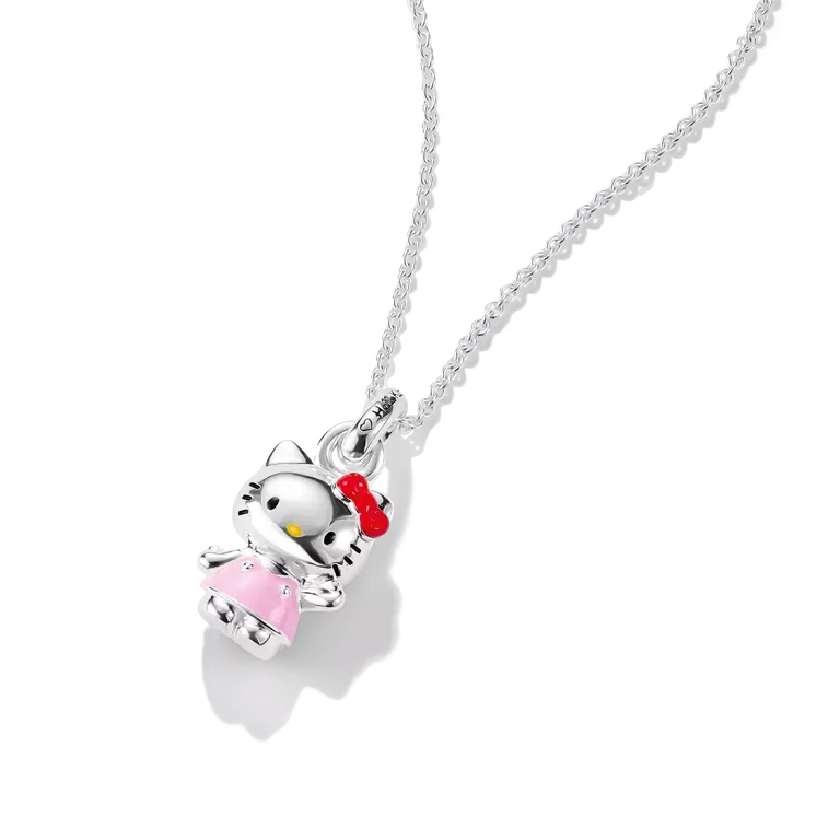 A silver Hello Kitty pendant necklace on a delicate silver chain, featuring a silver Hello Kitty figure wearing a pink dress and red bow, set against a clean white background.