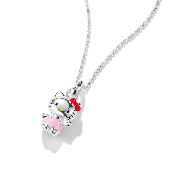 A silver Hello Kitty pendant necklace on a delicate silver chain, featuring a silver Hello Kitty figure wearing a pink dress and red bow, set against a clean white background.