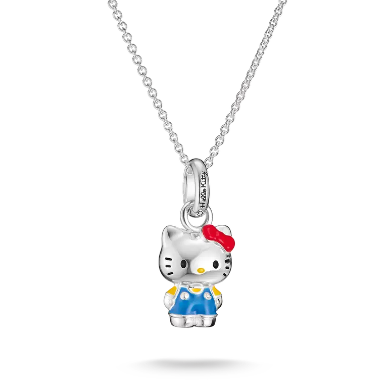 A silver Hello Kitty pendant necklace featuring a detailed character charm with blue overalls, yellow shoes, and a red bow, suspended from a delicate silver chain against a white background.