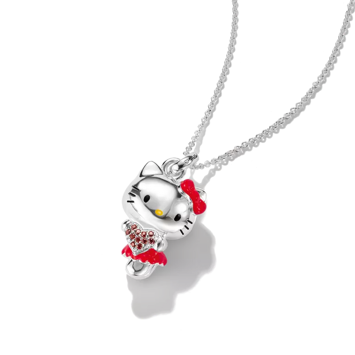 A silver Hello Kitty necklace featuring a silver cat pendant with red bow and dress details, shown on a clean white background.