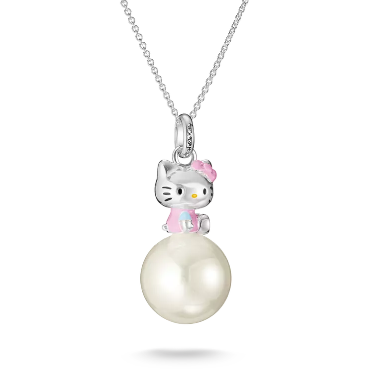 A silver pendant necklace featuring a Hello Kitty character sitting on a large white pearl, suspended from a delicate silver chain against a white background.