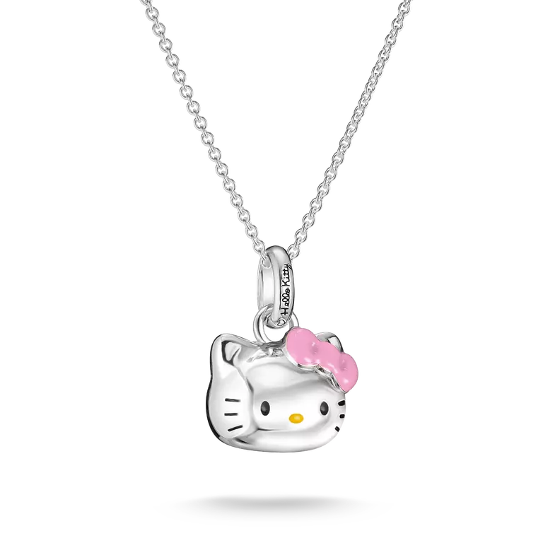 A silver Hello Kitty pendant necklace featuring a polished silver cat head with a pink bow and small yellow nose, suspended from a delicate silver chain against a white background.