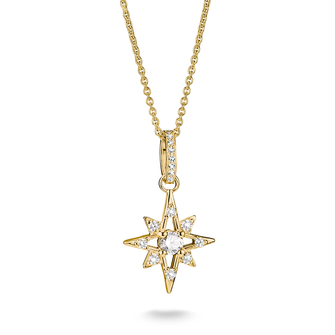 A gold starburst pendant necklace with a central round clear gemstone and smaller clear stones along the points, suspended from a gold chain on a white background.
