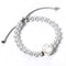 Pearl bracelet with a silver bunny charm on a white background
