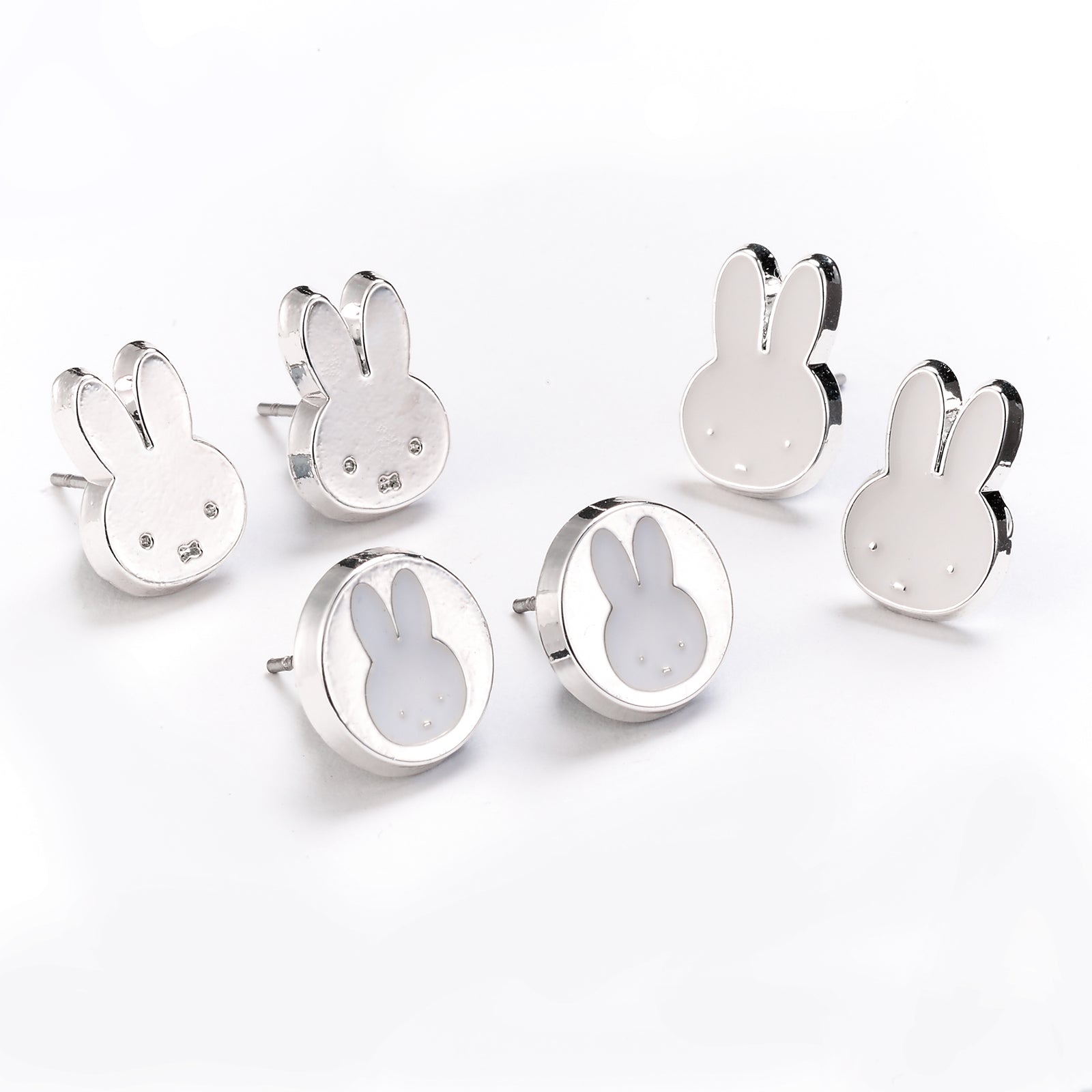 Set of silver bunny-shaped earrings on a white background