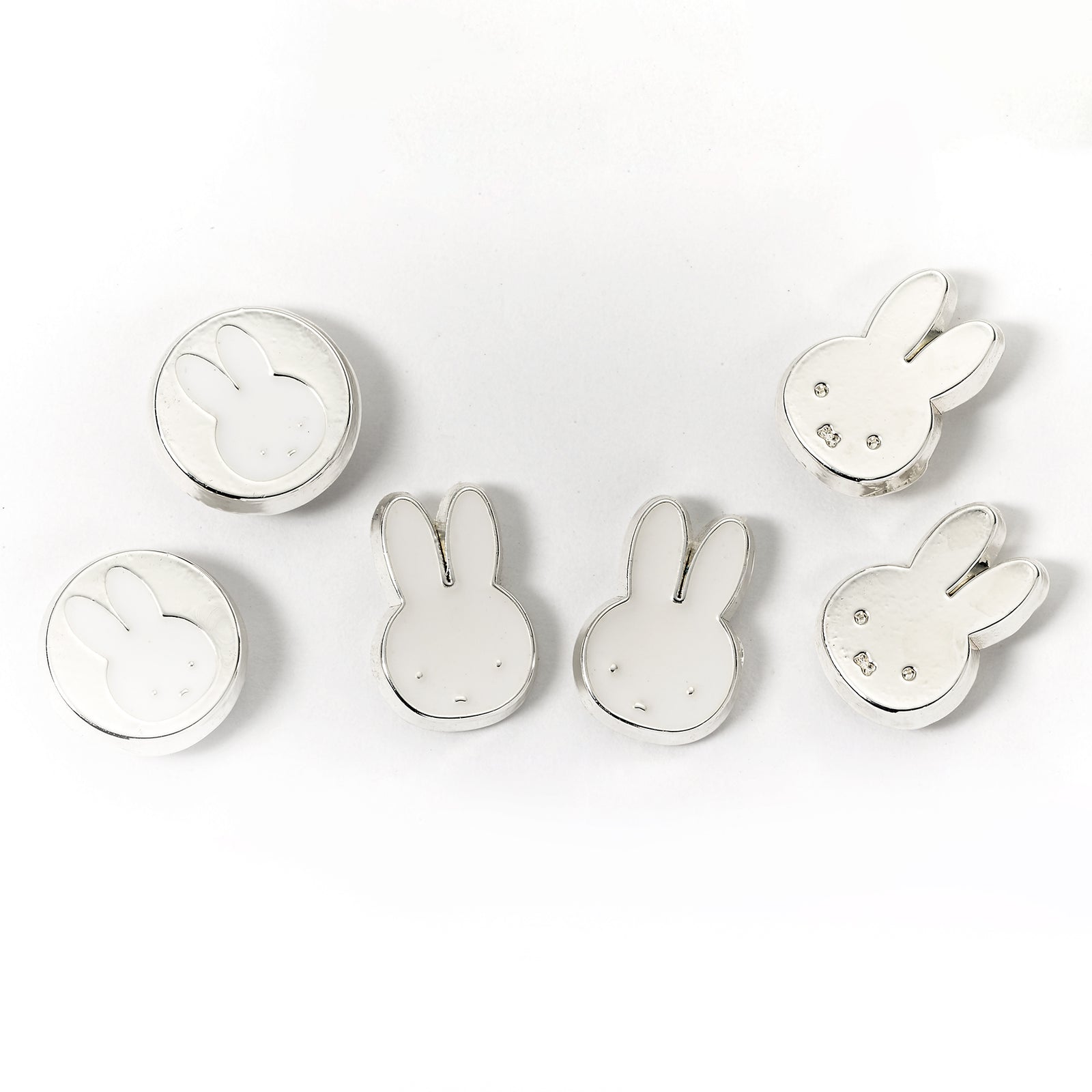 Set of silver bunny-shaped earrings on a white background