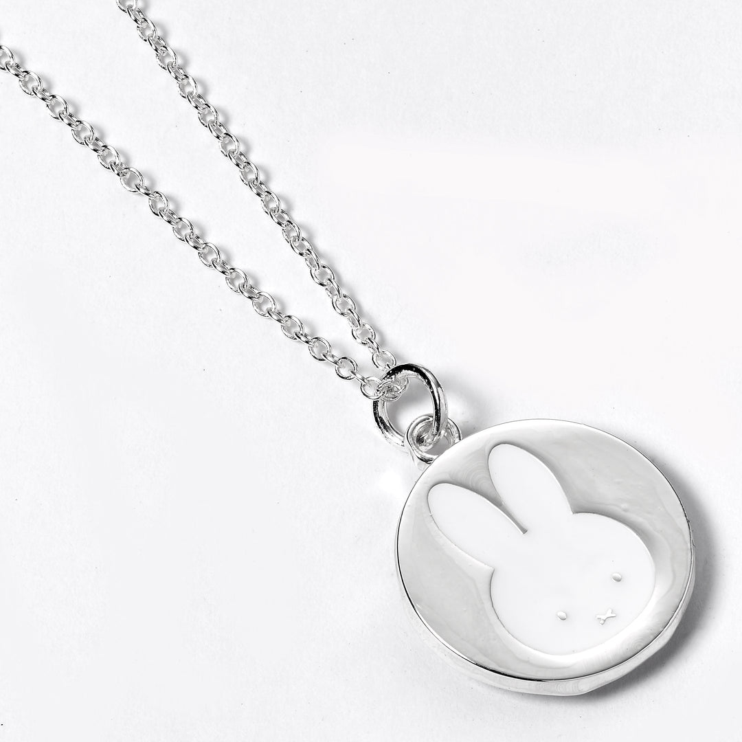 Silver necklace with a round pendant featuring a rabbit design on a white background