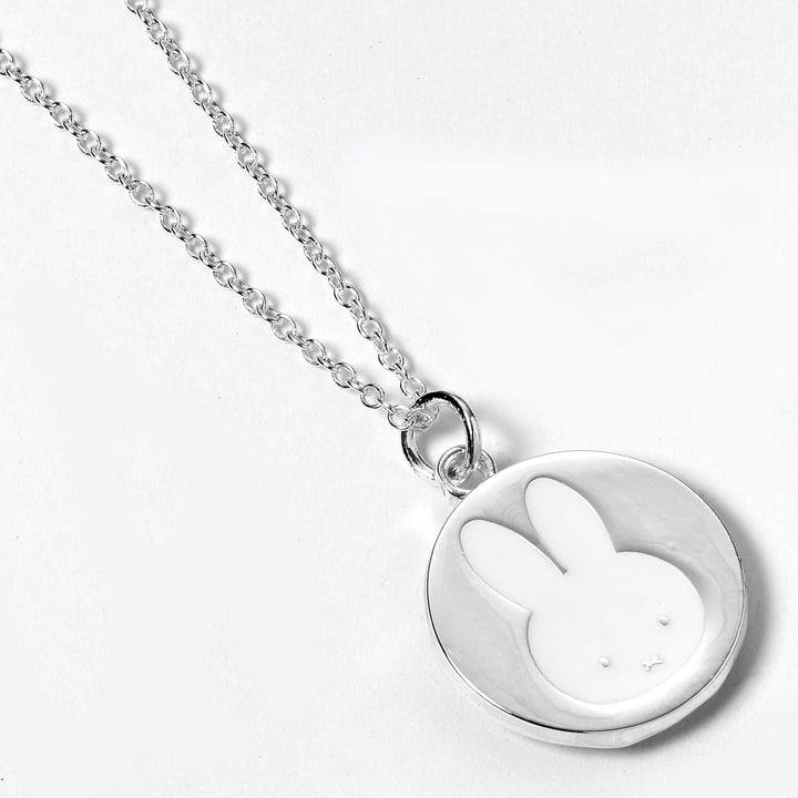 Silver necklace with a round pendant featuring a rabbit design on a white background