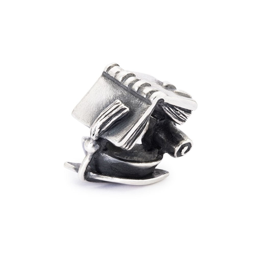 Metallic charm resembling a small engine on a white background