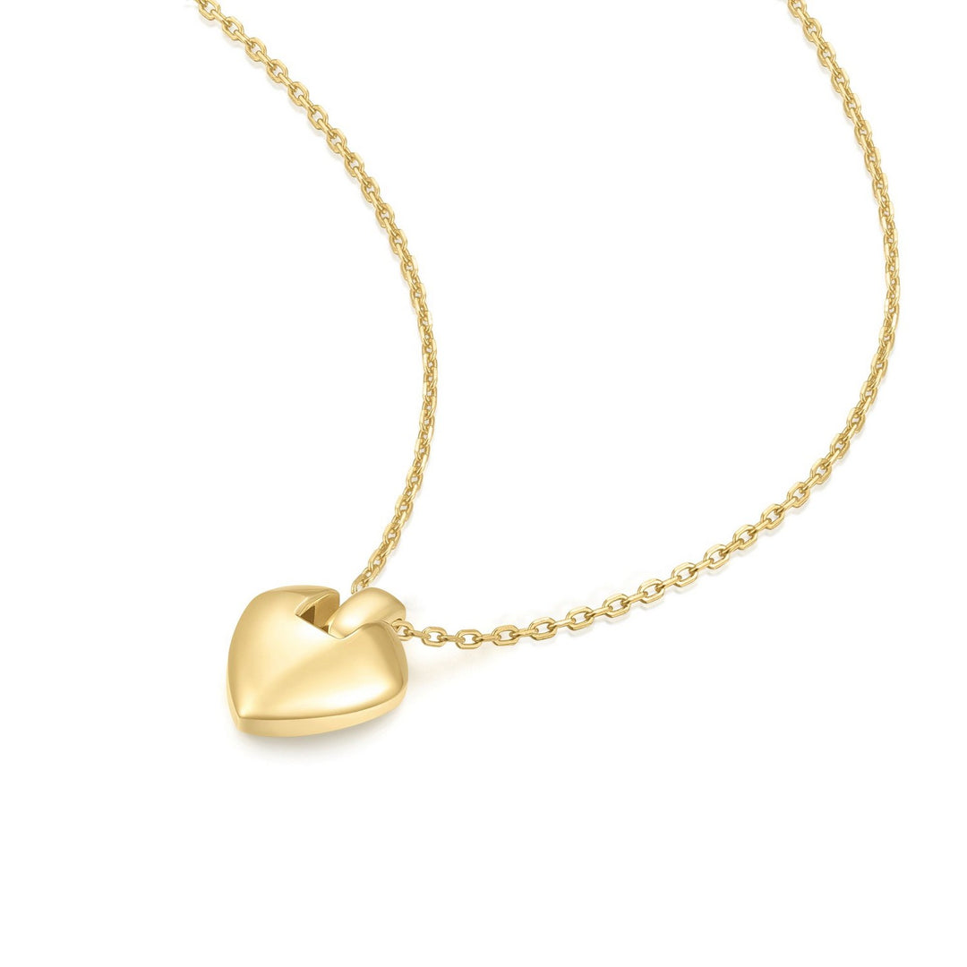 Gold heart-shaped pendant on a chain against a white background