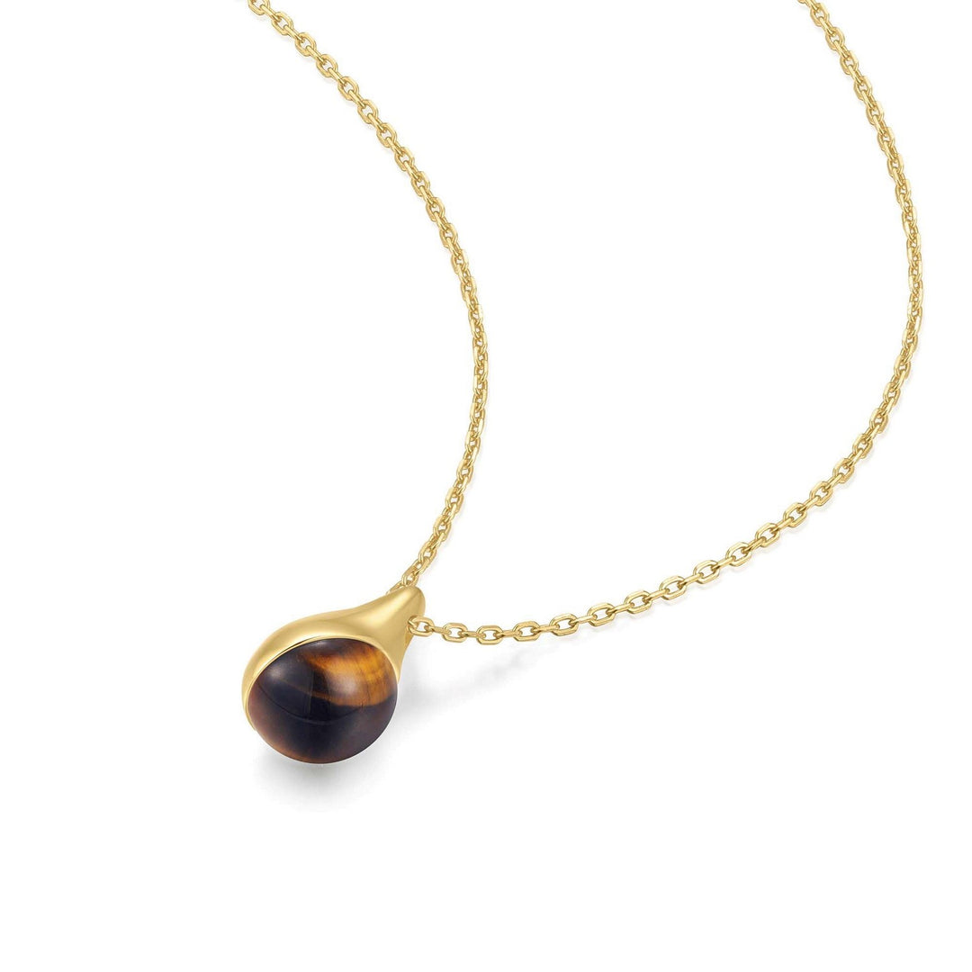 Gold necklace with a tiger's eye pendant on a white background