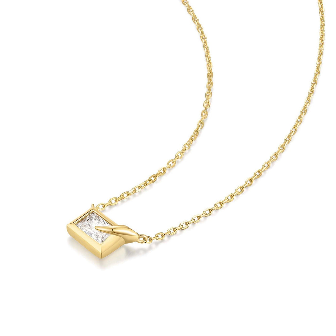 Gold necklace with a diamond pendant on a white background