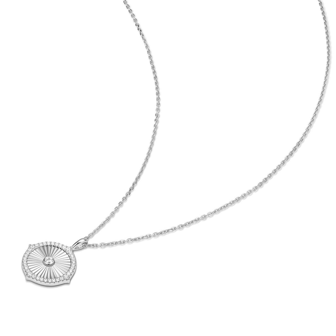 Silver necklace with a round pendant on a white background