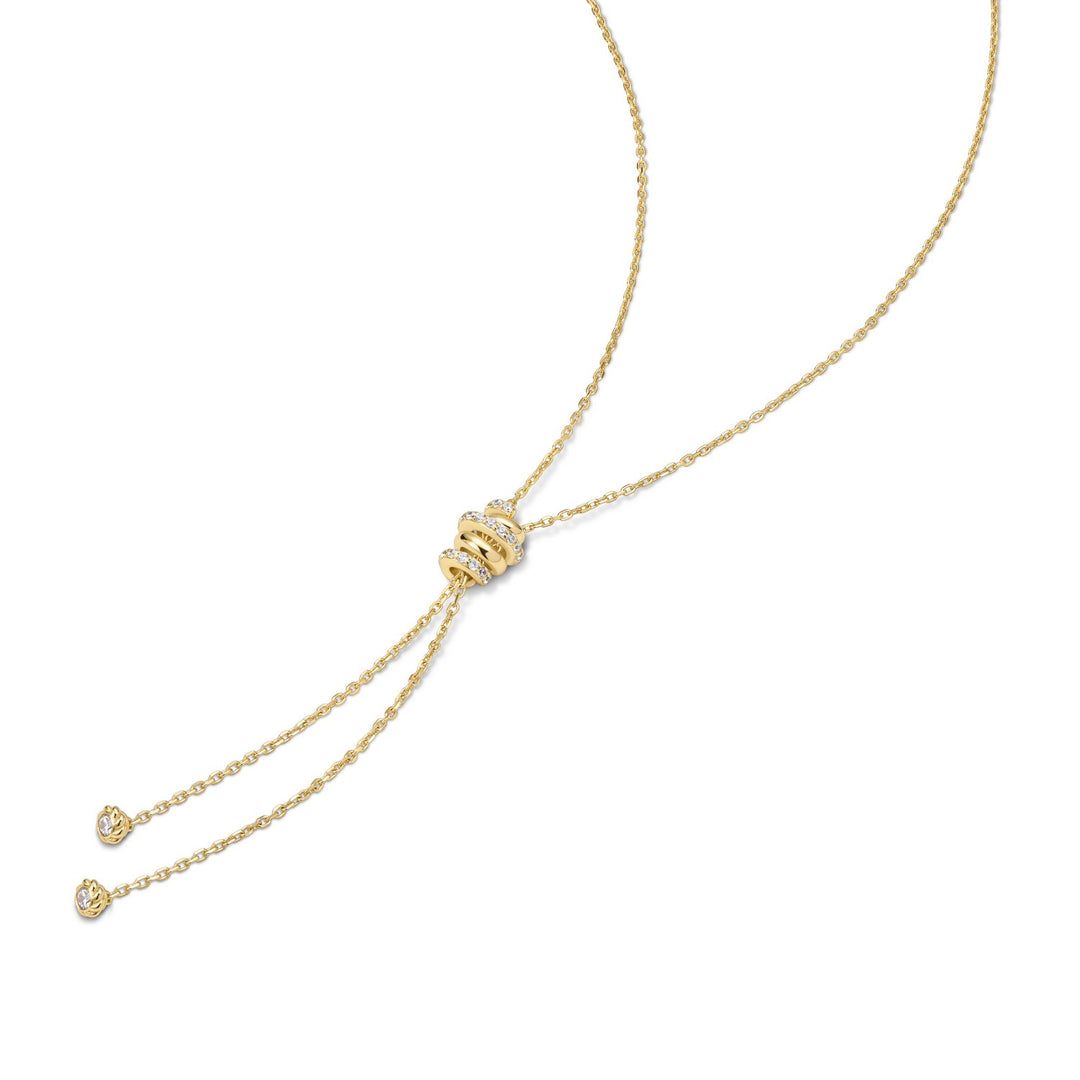 Gold necklace with a heart-shaped pendant on a white background