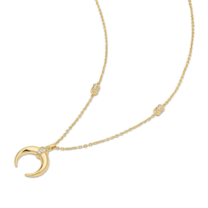 Gold necklace with a crescent moon pendant on a white background