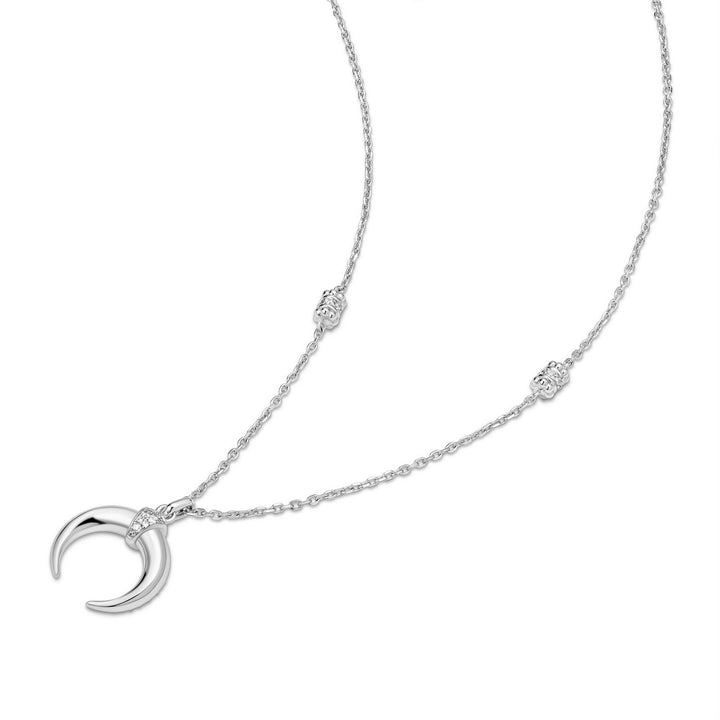 Silver necklace with a crescent moon pendant on a white background