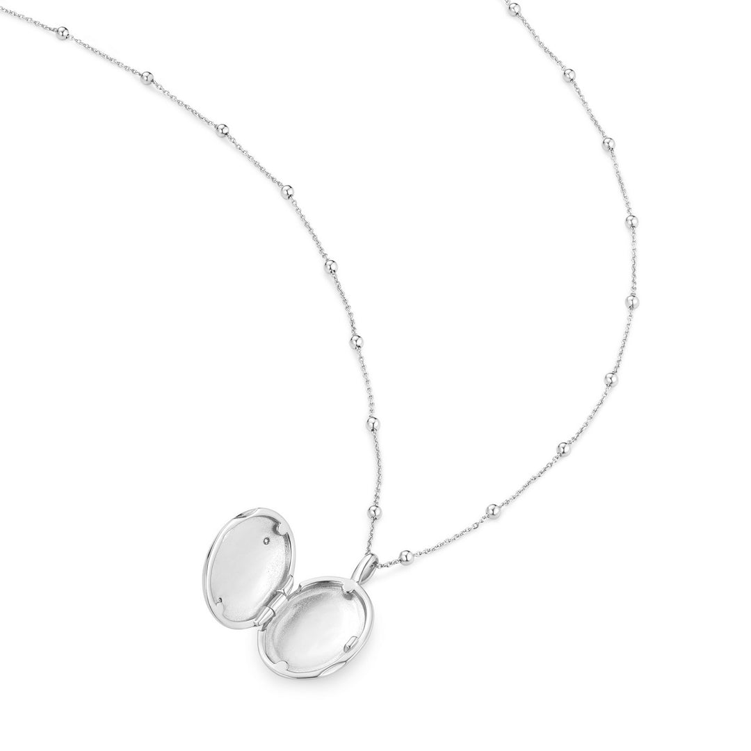 Silver locket necklace on a white background
