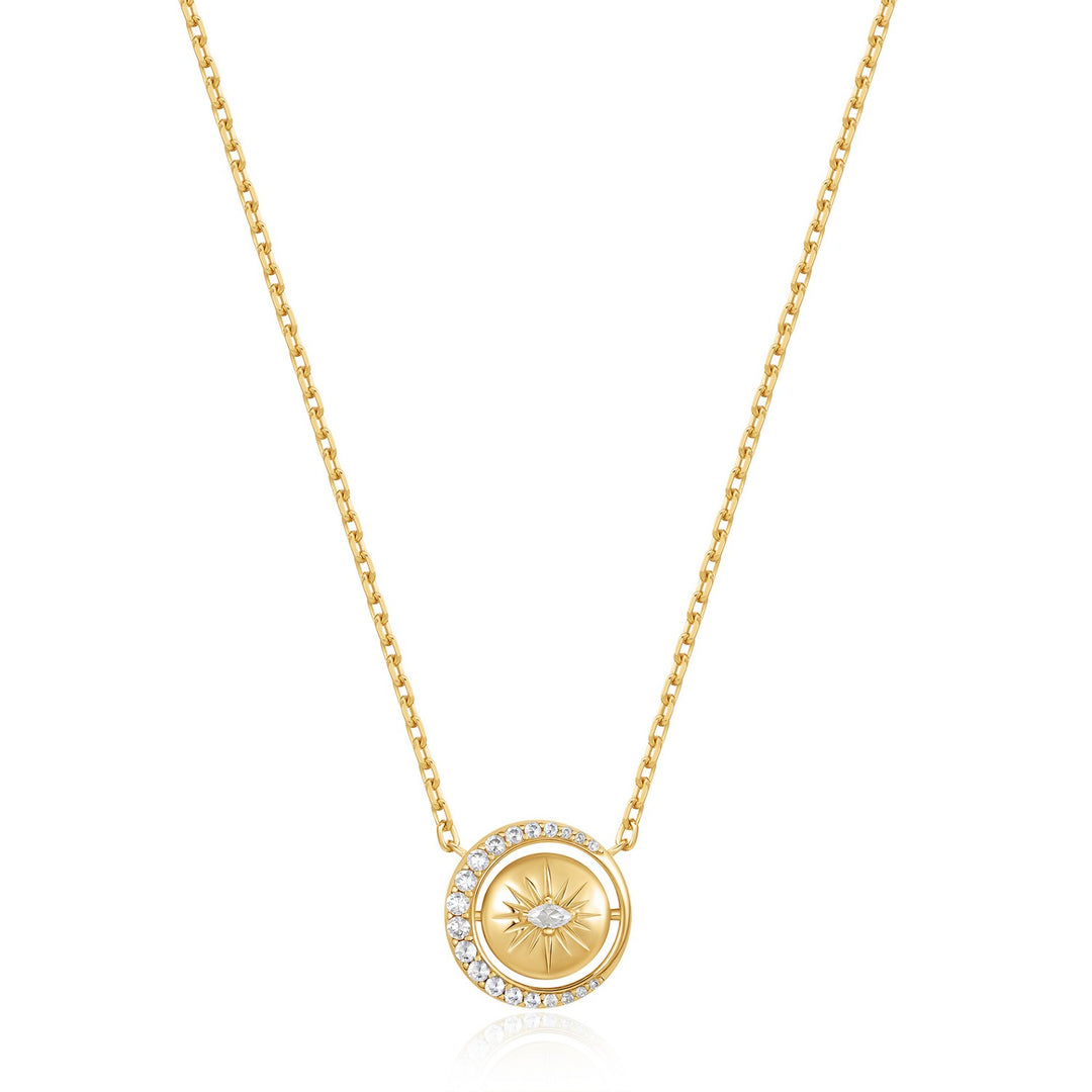Gold necklace with a circular pendant on a white background