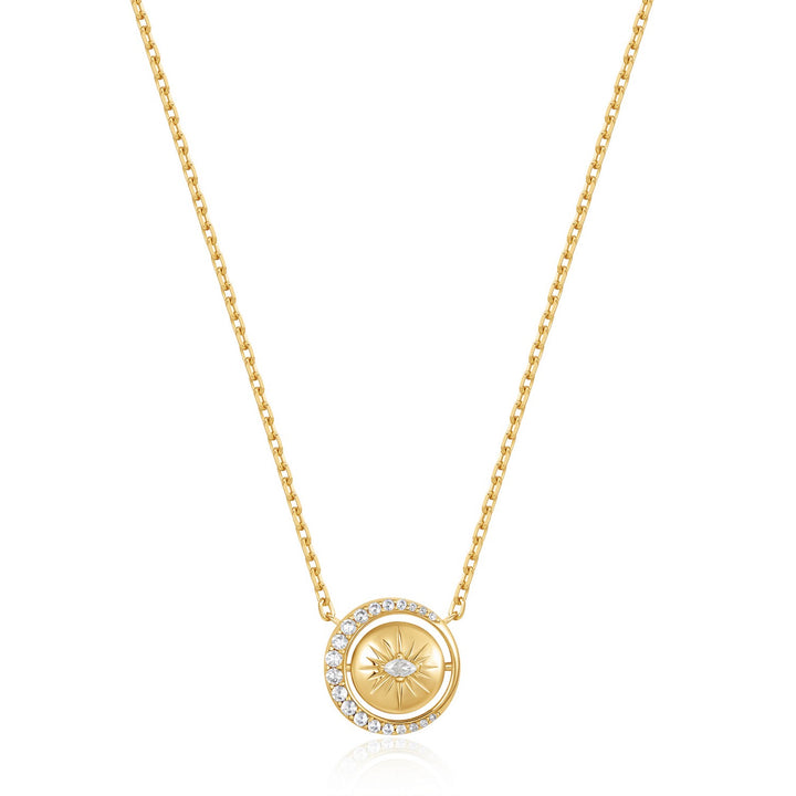 Gold necklace with a circular pendant on a white background