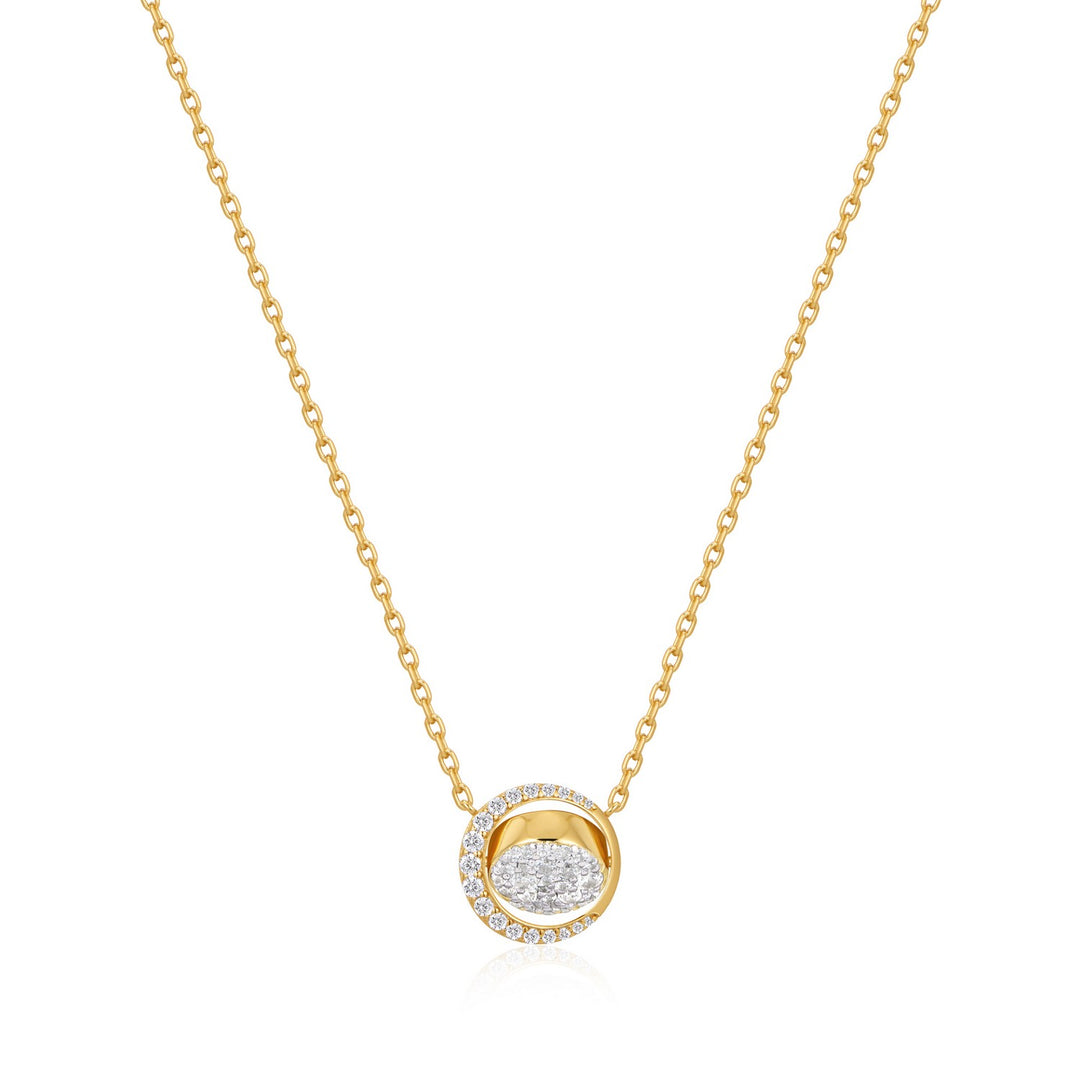 Gold necklace with a round pendant on a white background