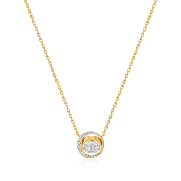 Gold necklace with a round pendant on a white background