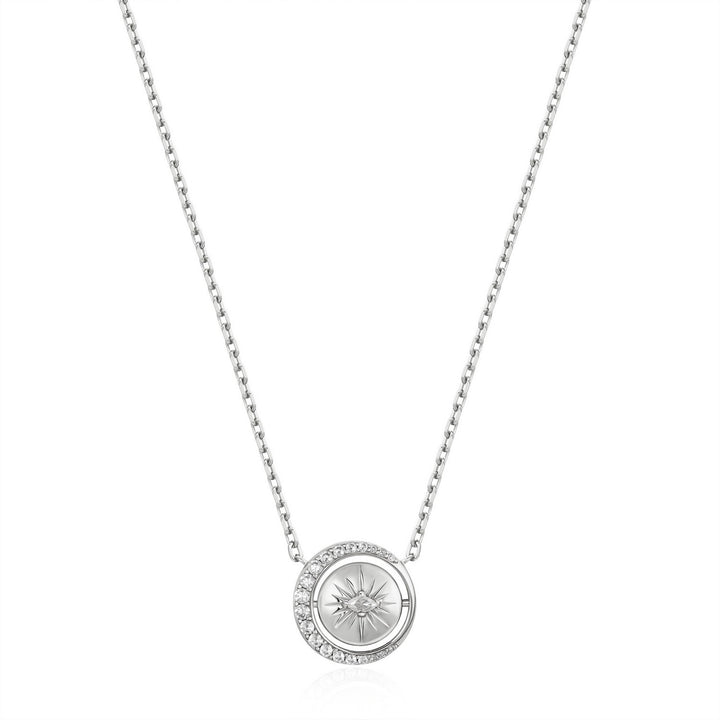 Silver necklace with a round pendant on a white background