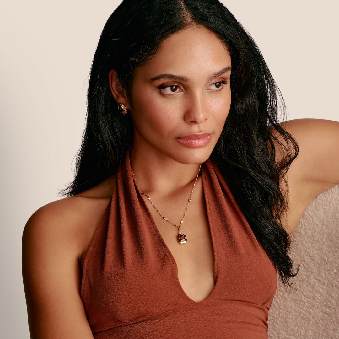 Woman wearing a rust-colored halter top against a neutral background