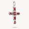 Silver cross pendant with red gemstones on a white background